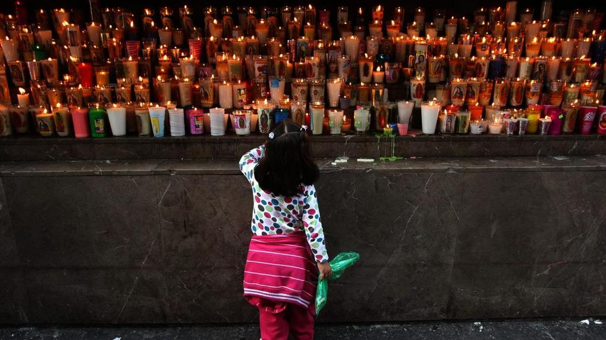 Papal mass: A youngster looks over the many candles that have been lit by pilgrims visiting the Basilica of Our Lady of Guadalupe in Mexico City, in a December 2013 file image. The shrine is where Pope Francis will conduct a Holy Mass on Saturday, Feb. 13, 2016. It was built near the hill of Tepeyac, where Our Lady of Guadalupe is believed to have appeared to Saint Juan Diego Cuauhtlatoatzin. (Genaro Molina/Los Angeles Times/TNS)