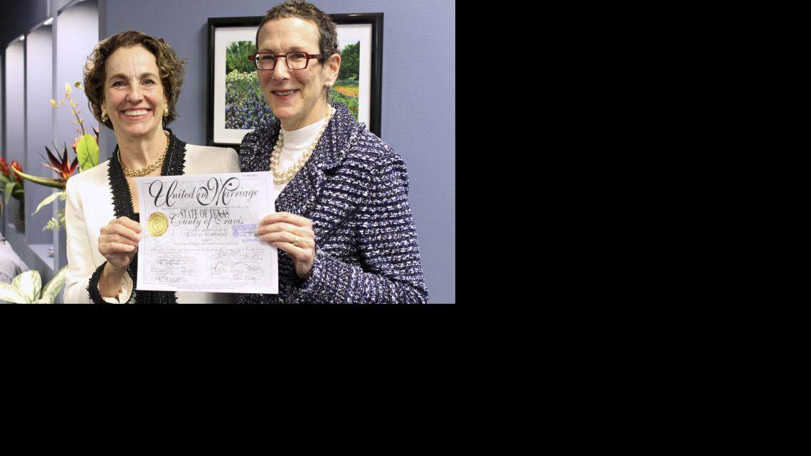 
Suzanne Bryant (left) and Sarah Goodfriend hold up their marriage license after a press conference on Thursday afternoon Feb. 19, 2015. They became the first same-sex couple to marry in Texas. Texas Attorney General Ken Paxton later declared the license void.


