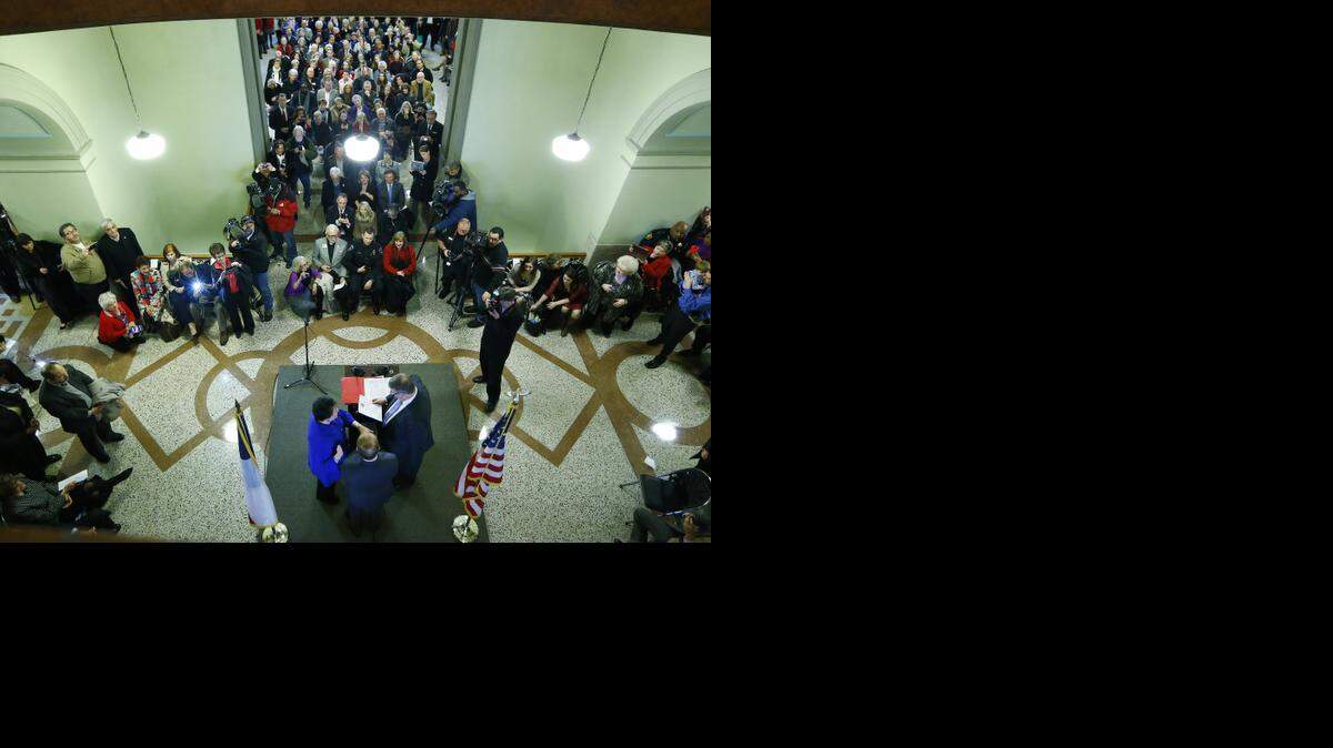 
Sheriff Dee Anderson, right, swears in Sharen Wilson as Criminal District Attorney for Tarrant County before a standing-room-only crowd in the Tarrant County Courthouse in Fort Worth, TX Thursday, Jan. 1, 2015. 
