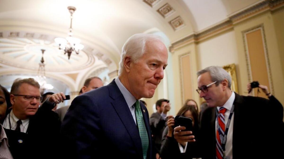 Senate Majority Whip Sen. John Cornyn, R-Texas, center, will see his plan to toughen background checks for prospective gun buyers included in a new budget bill.