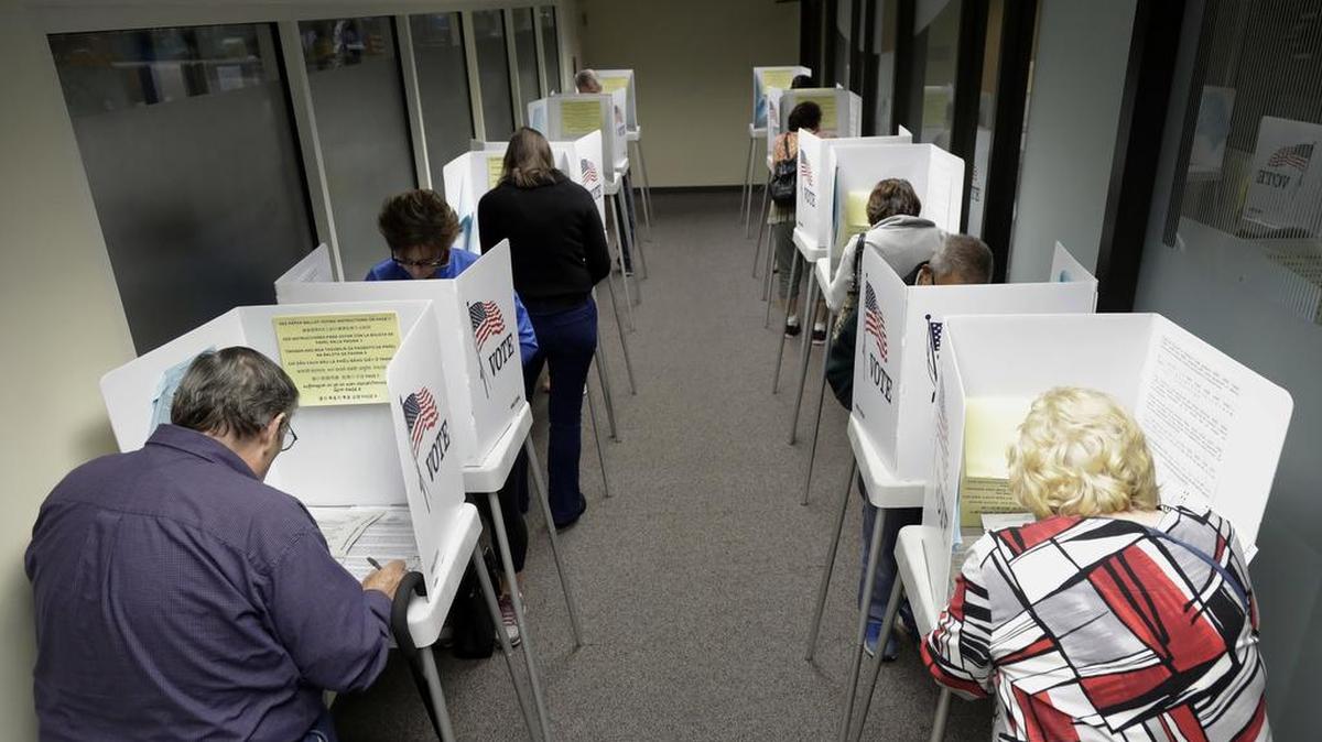 Voters cast their ballots at the Santa Clara County Registrar of Voters on Oct. 24 in San Jose, Calif.