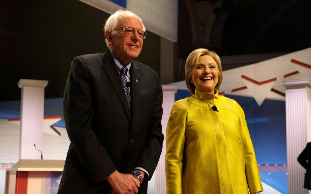 Democratic presidential candidates Sen. Bernie Sanders, I-Vt, left, and Hillary Rodham Clinton take the stage before the Democratic presidential primary debate at the University of Wisconsin-Milwaukee on Thursday,.