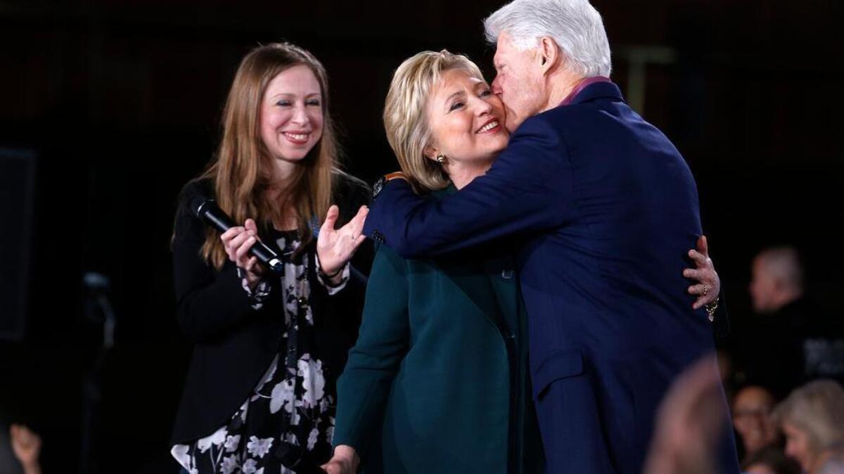 Live: Democratic Presidential candidate Hillary Clinton gets a kiss from her husband and former President Bill Clinton as daughter Chelsea looks on during a rally at the Clark County Government Center Friday, Feb. 19, 2016. (Steve Marcus/Las Vegas Sun VIA AP)