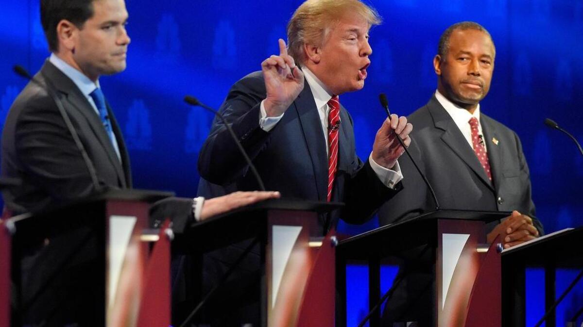 Live: Donald Trump, center, makes a point as Marco Rubio, left, and Ben Carson look on during the CNBC Republican presidential debate at the University of Colorado, Wednesday, Oct. 28, 2015, in Boulder, Colo. (AP Photo/Mark J. Terrill)