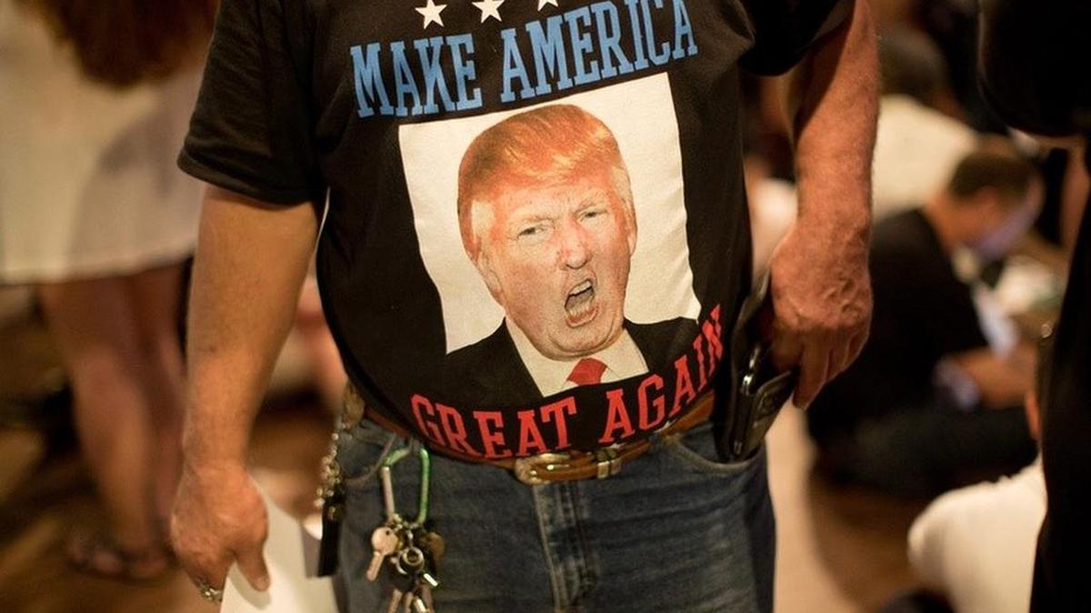 A Trump fan waits for a Donald Trump rally June 16 to begin at Gilley's in Dallas.