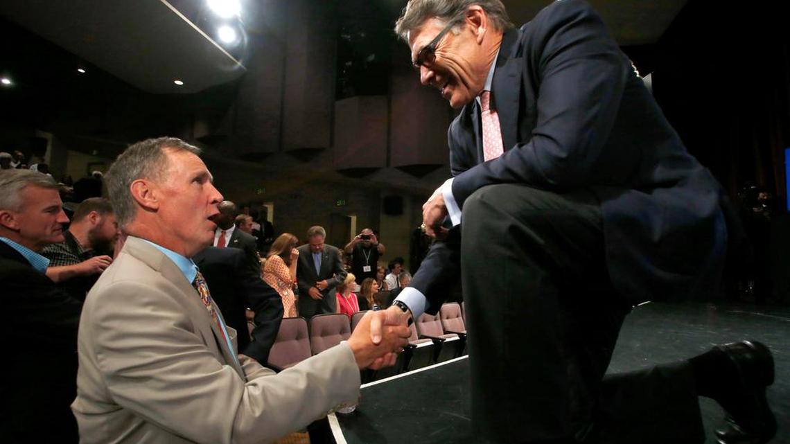 
Republican presidential candidate and former Texas Gov. Rick Perry speaks to New Hampshire Union Leader Publisher Joe McQuaid, left, after a forum Monday, Aug. 3, 2015, in Manchester, N.H.
