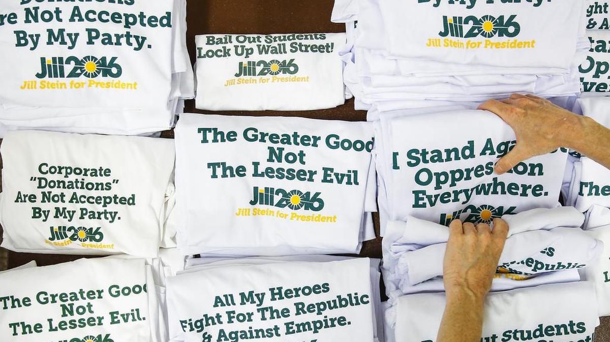 Green Party volunteer Lisa Canar, from Seattle, folds Jill Stein shirts as people arrive for the Green Party Convention Thursday in Houston.