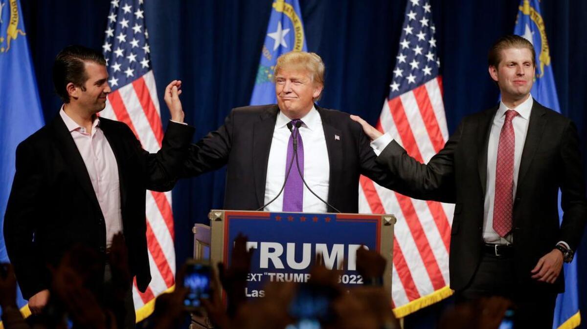 Live: Republican presidential candidate Donald Trump, center, speaks as his son's Donald Trump, Jr., left and Eric look on during a caucus night rally Tuesday, Feb. 23, 2016, in Las Vegas. (AP Photo/Jae C. Hong)