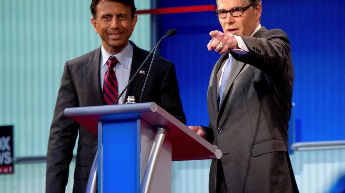 
The debate season has begun. Republican presidential candidates Louisiana Gov. Bobby Jindal, left, and former Texas Gov. Rick Perry, right, speak on stage during a commercial break during a pre-debate forum at the Quicken Loans Arena, Thursday, Aug. 6, 2015, in Cleveland. Seven of the candidates have not qualified for the primetime debate. (AP Photo/Andrew Harnik)
