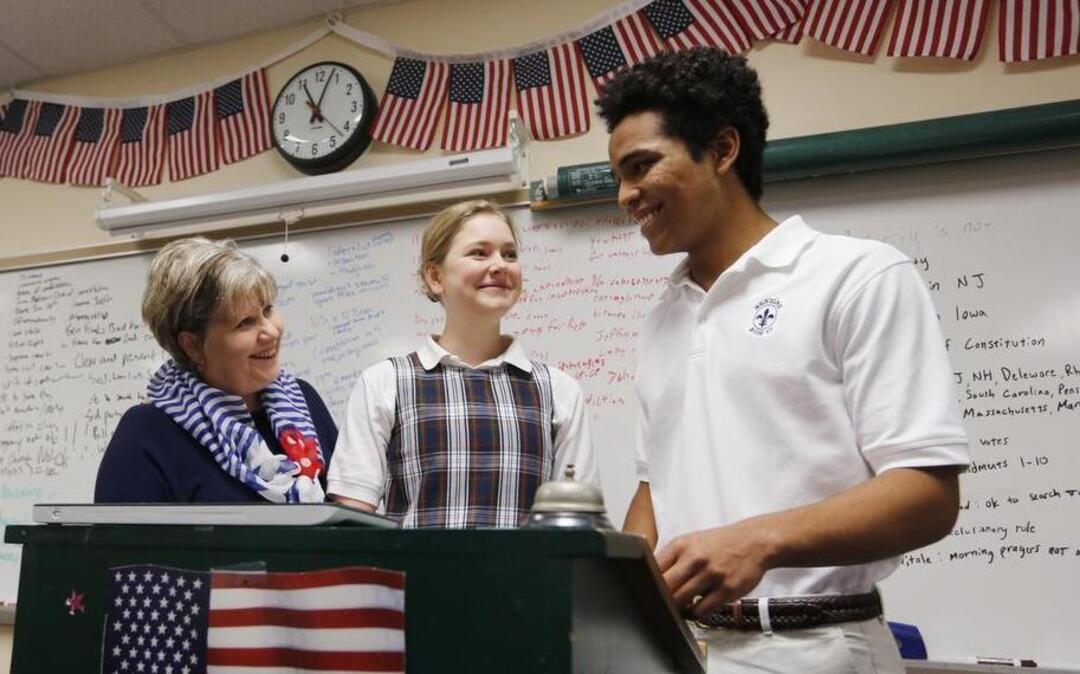 All Saints Episcopal School government teacher Ann Baldwin, left, talks with Claire Mildren and Eric Whitfield about the upcoming trip to Washington D.C. for the inauguration. Baldwin will be taking 39 students.