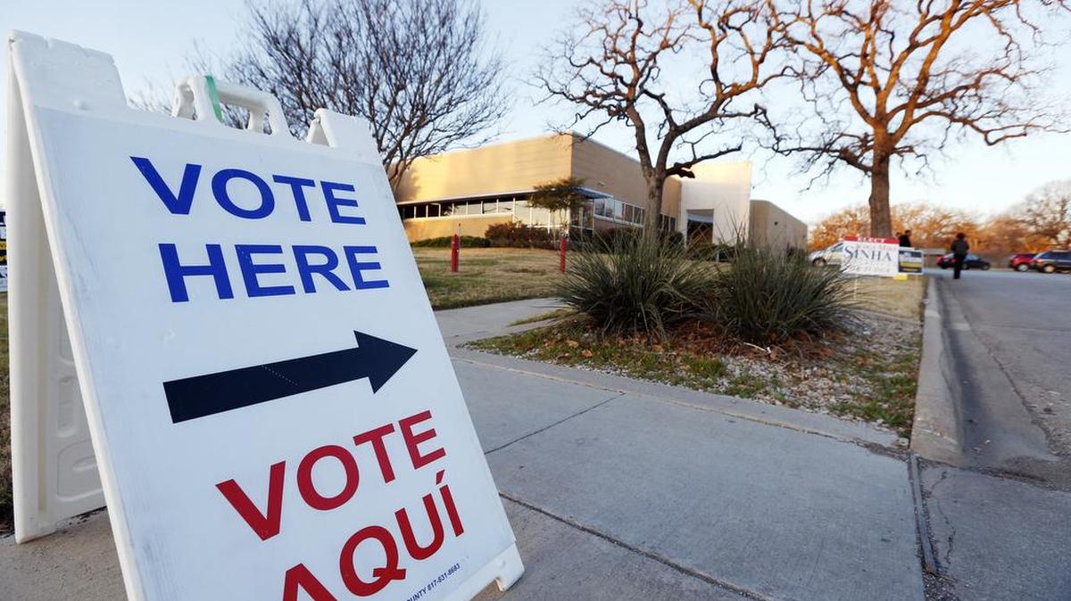 A sign points voters to early voting in Fort Worth.