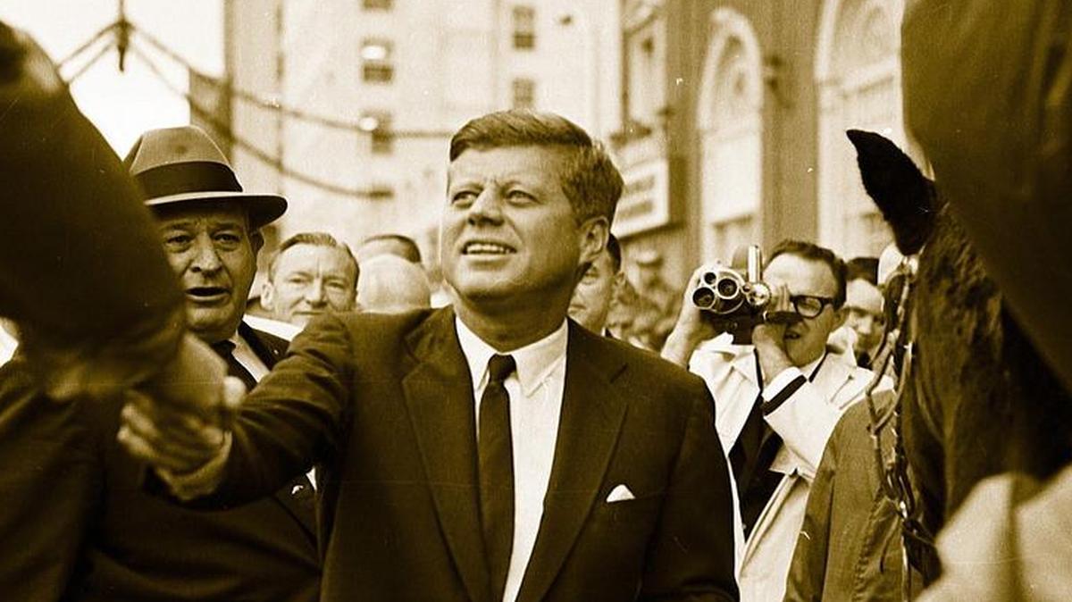 Pres. John F. Kennedy greets Fort Worth law enforcement crowd control officers who are on horseback in front of Hotel Texas, 11/22/1963.