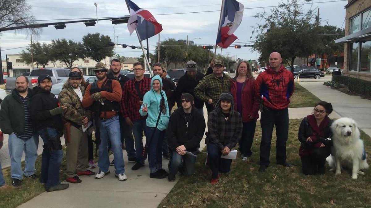A group of Open Carry supporters wore their holstered handguns or long guns at a walk in Arlington on Jan. 1. They handed out information to people wanting to learn more about Open Carry and were hoping to draw more attention to the new law.