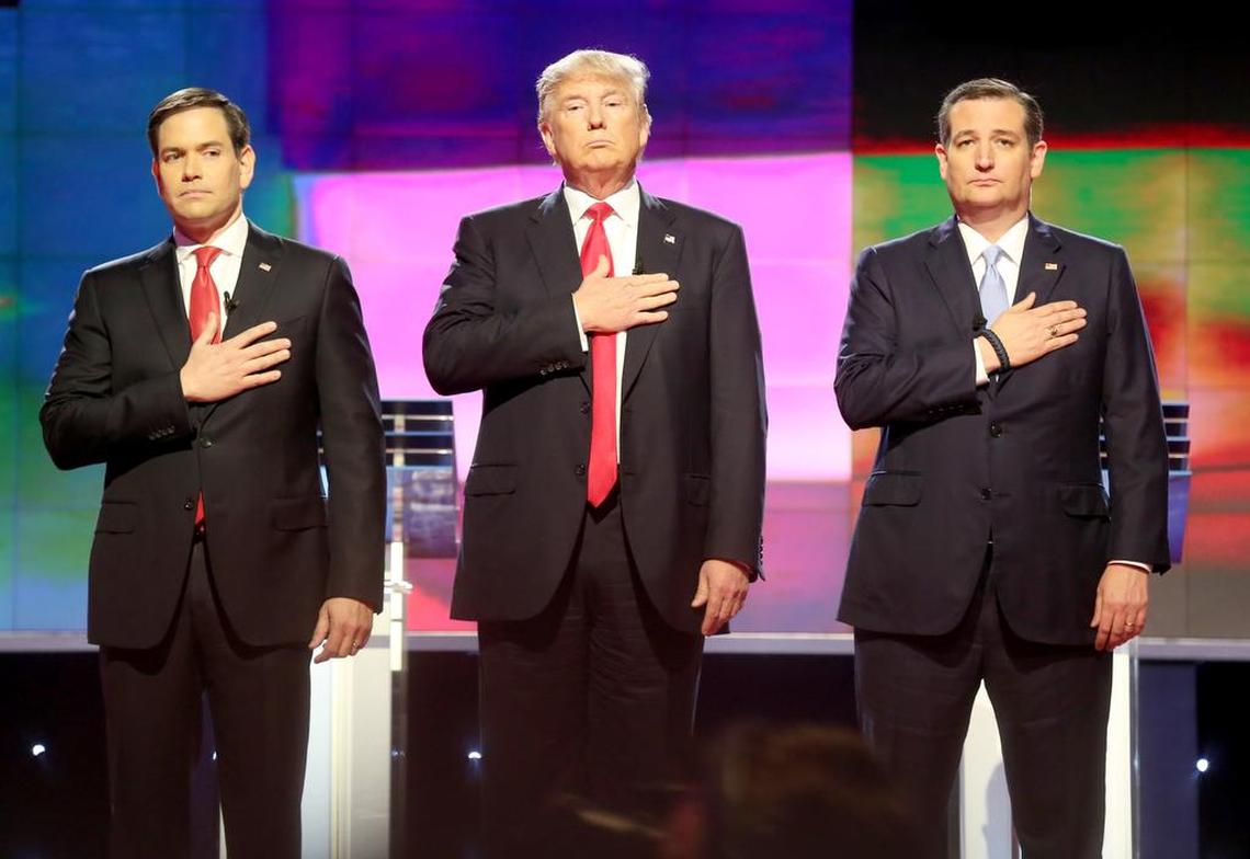 File: Republican presidential candidates, Sen. Marco Rubio, R-Fla, from left, Donald Trump and Sen. Ted Cruz, R-Texas stand up for the national anthem during a primary debate at the University of Miami in Coral Gables, a suburb of Miami on Thursday, March 10, 2016. (Mike Stocker/The Miami Herald via AP) MANDATORY CREDIT