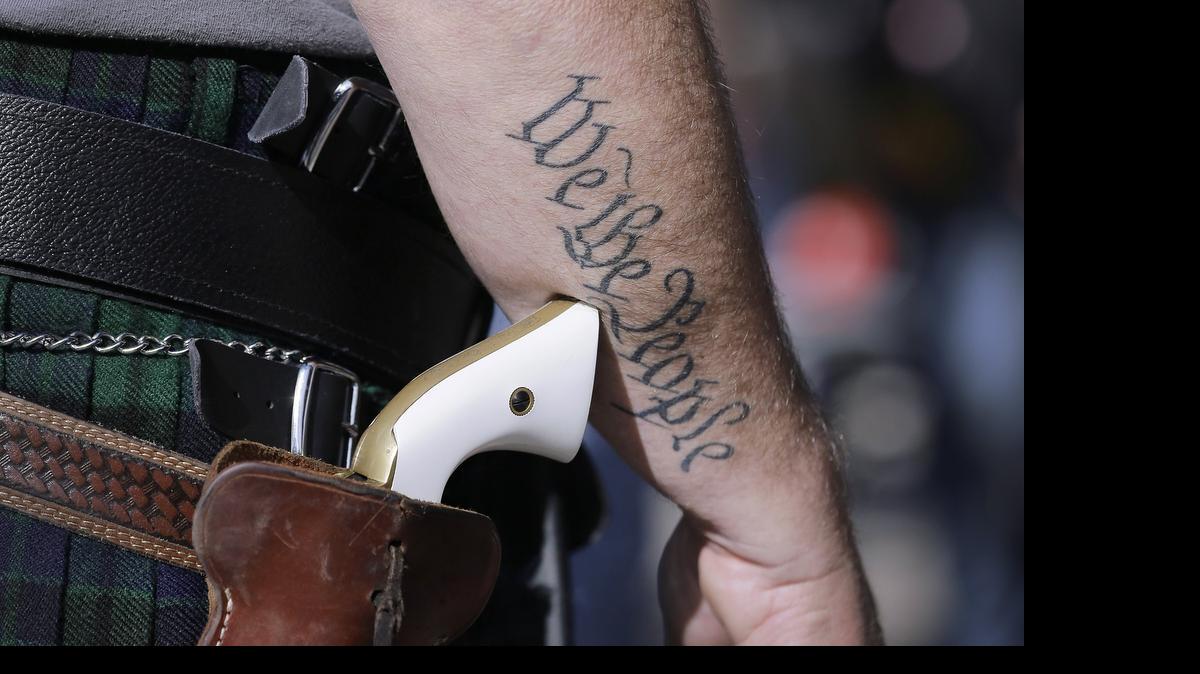 
Scott Smith, a supporter of open carry gun laws, wore a pistol as he prepared for a rally at the Capitol in January.
