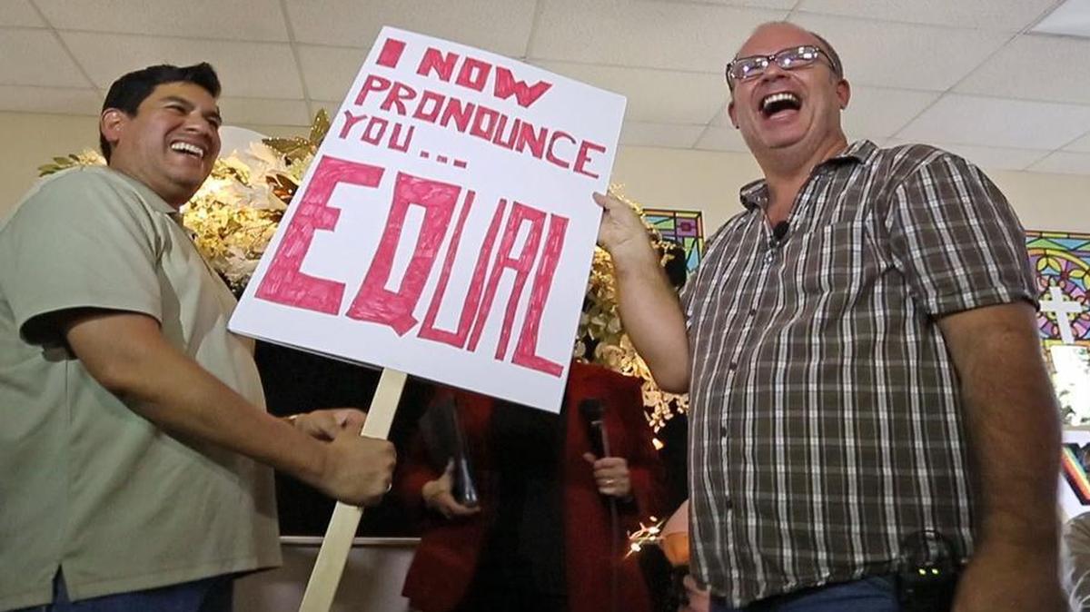 After Victor Lopez (left) and Michael Zeigler (right), partners for twenty years, were married, they held a sign signifying their union as well as the day. After the Supreme Court’s gay marriage ruling, supporters of gay marriage met Friday, June 26, 2015, at Celebration Community Church in Fort Worth.