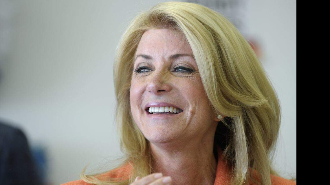 
Wendy Davis, during her gubernatorial campaign, visited workers at her campaign field office at La Gran Plaza in Fort Worth in October 2014.
