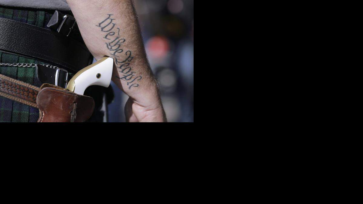 
Scott Smith, a supporter of open carry gun laws, wore a pistol as he prepared for a rally at the Capitol in January. 

