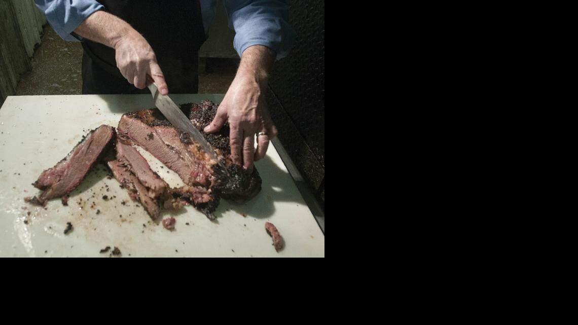 
Eddie Deen, owner of Eddie Deen & Company Catering, slices brisket at his company in Terrell in early January. Brisket will be among the food he provides at the 2015 Inaugural barbecue.


