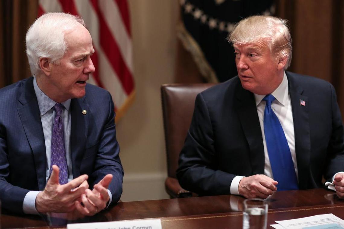 President Donald Trump, right, listens as Senator John Cornyn (R-Texas) speaks during a meeting with bipartisan members of Congress on school and community safety in the Cabinet Room of the White House on Wednesday, Feb. 28, 2018, in Washington, D.C.