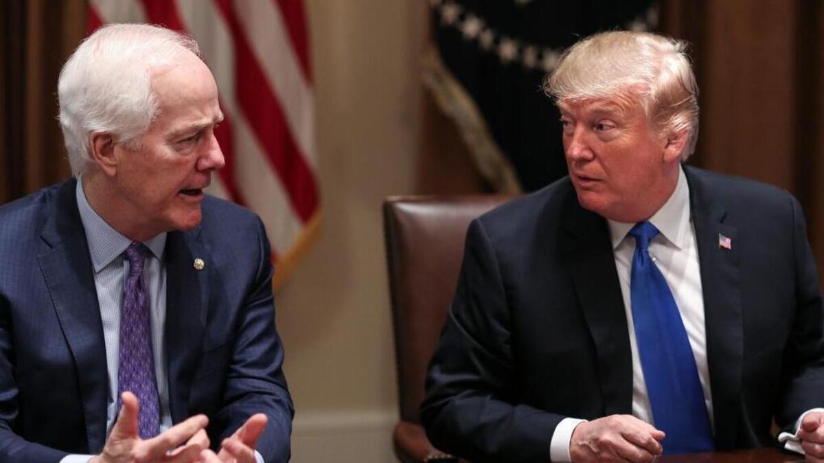President Donald Trump, right, listens as Senator John Cornyn (R-Texas) speaks during a meeting with bipartisan members of Congress on school and community safety in the Cabinet Room of the White House on Wednesday, Feb. 28, 2018, in Washington, D.C.
