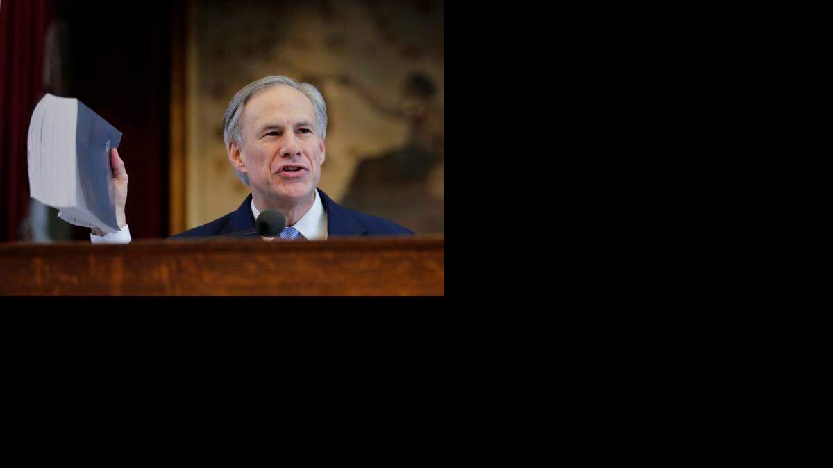 
Texas Gov. Greg Abbott holds a book about Texas school laws as he delivers his State of the State address Tuesday in Austin, Texas. Abbott told lawmakers that roads, education and border security are the biggest issues facing Texans. 
