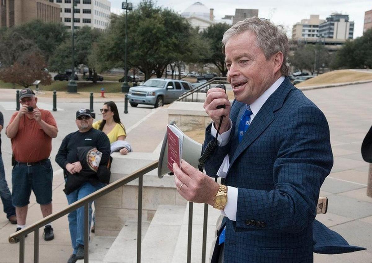 Sen. Don Huffines, R-Dallas, shows his copy of the U.S. Constitution during a 2017 rally at the Texas Capitol.