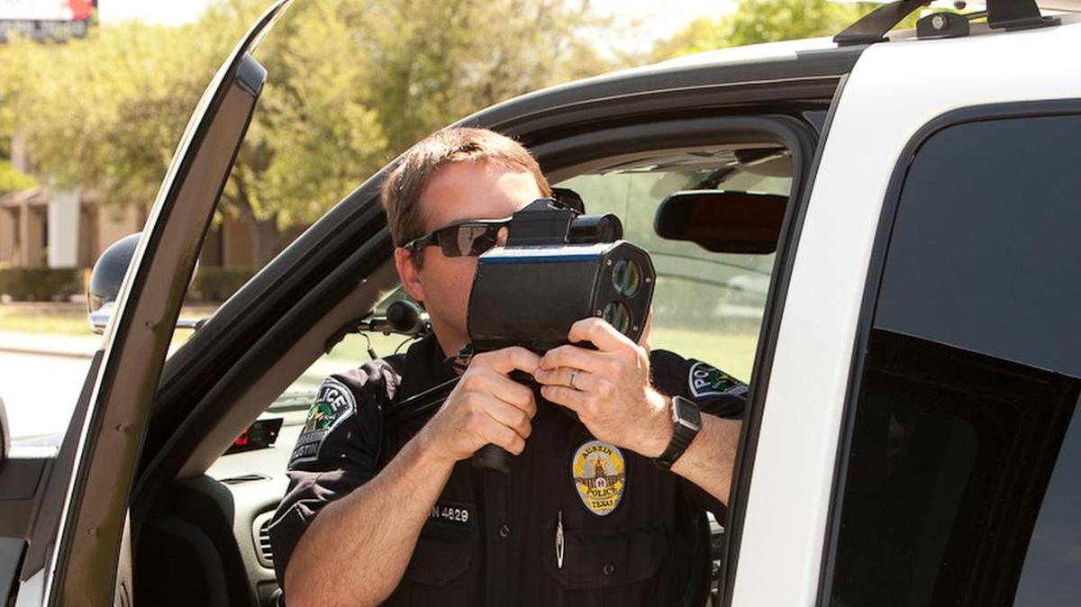 Austin Police Department Senior Patrol officer S. Boughton uses radar to monitor vehicles along stretch of Austin highway in 2011.