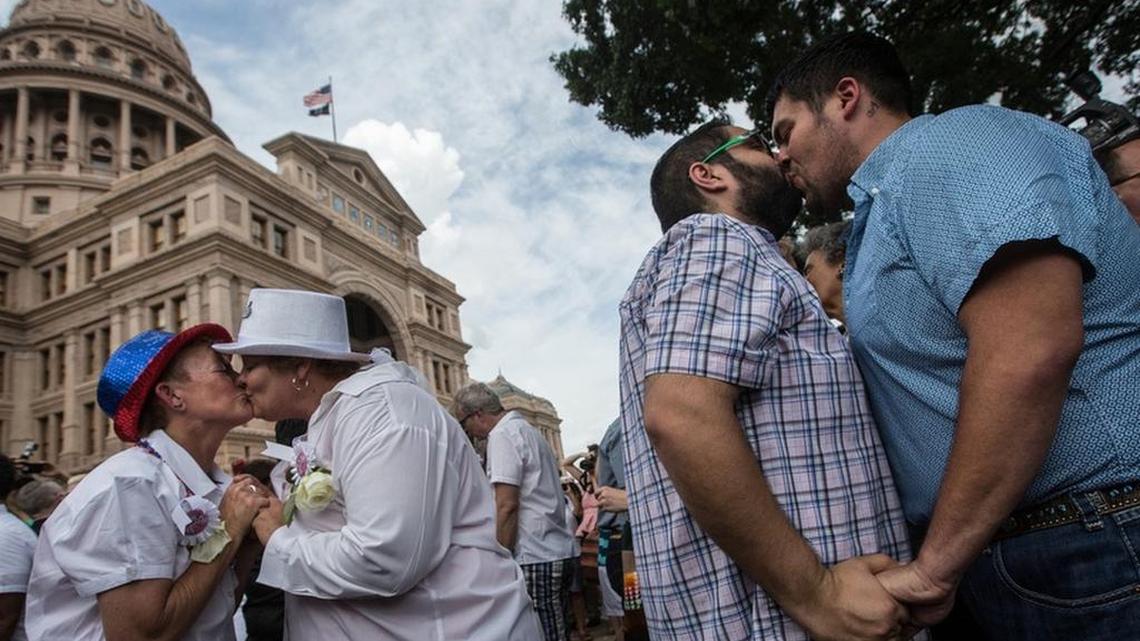 Couples embrace at the conclusion of the “Big Gay Wedding” ceremony on the south lawn of the Texas Capitol on July 4 after the Supreme Court legalized same-sex marriage in June.
