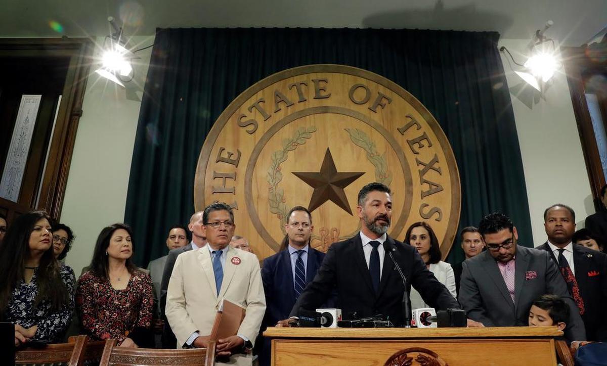 Texas Rep. Ramon Romero, D-Fort Worth, stands with fellow lawmakers and business leaders for a news conference outside the House Chambers at the Texas Capitol in Austin. Romero represents House District 90. The Supreme Court says it was drawn in a way that discriminates against minorities.