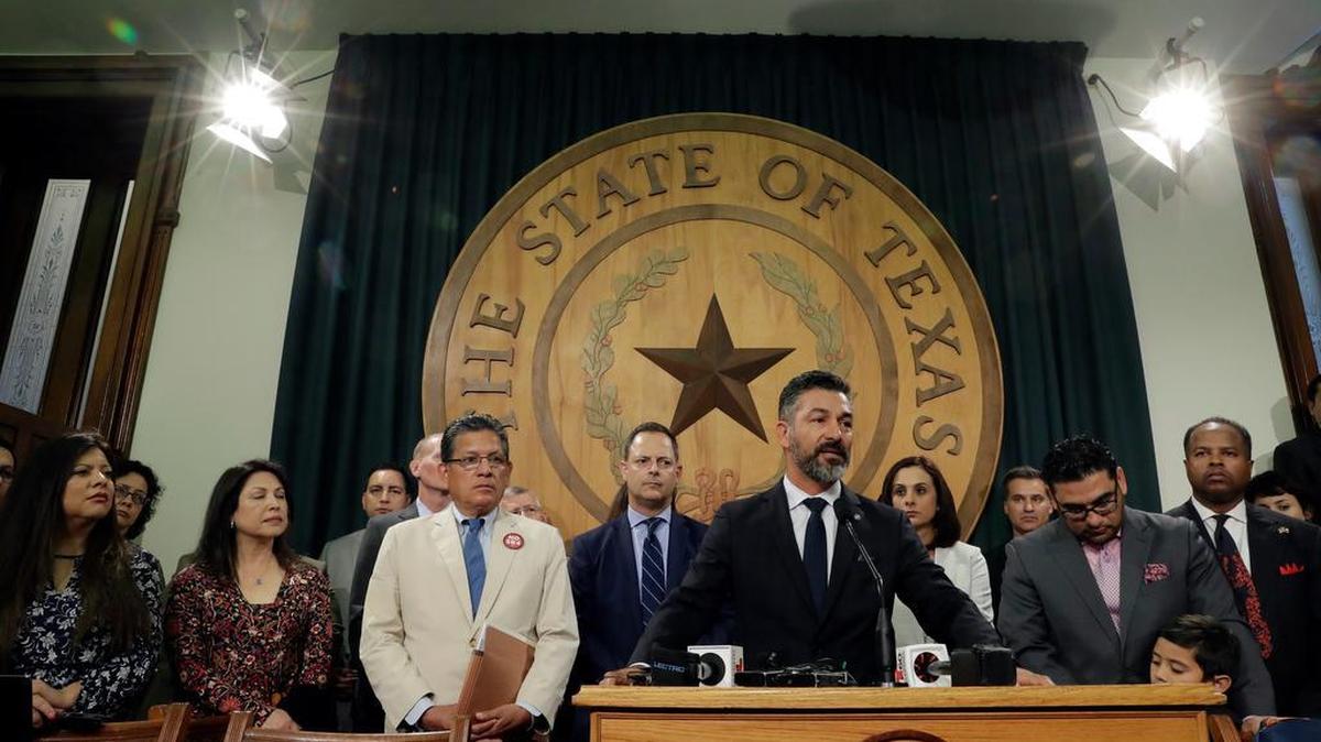 Texas Rep. Ramon Romero, D-Fort Worth, stands with fellow lawmakers and business leaders for a news conference outside the House Chambers at the Texas Capitol in Austin. Romero represents House District 90. The Supreme Court says it was drawn in a way that discriminates against minorities.