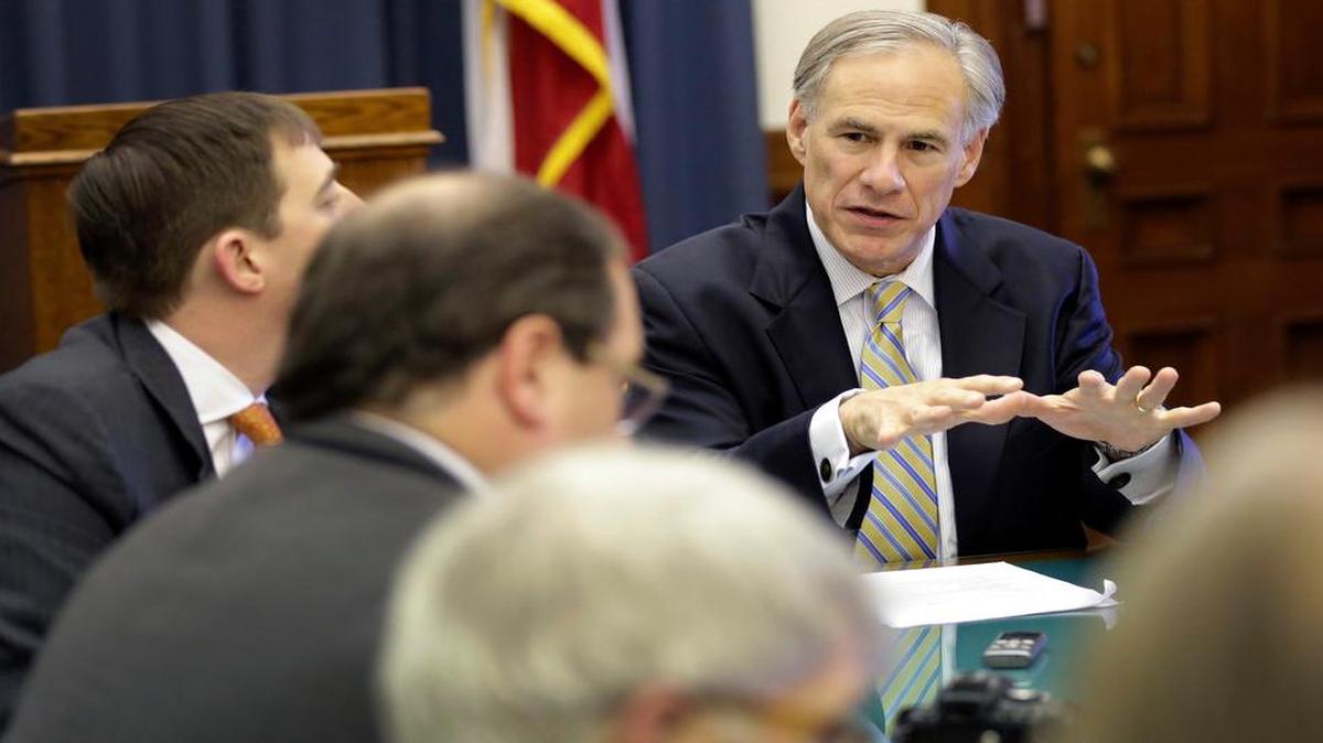 
Texas Gov. Greg Abbott, right, talks with reporters in his office at the Texas Capitol, Wednesday, June 3, 2015. 
