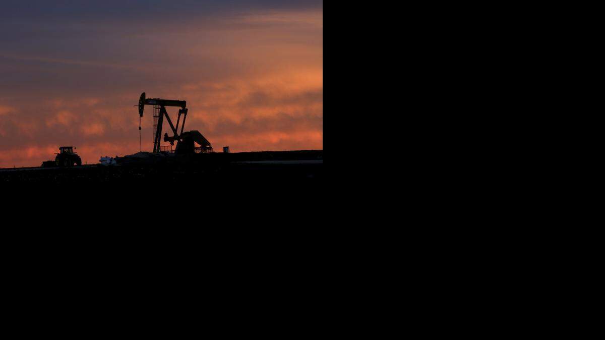 
In this photo from Monday, Dec. 22, 2014, a well pump works at sunset on a farm near Sweetwater, Texas. At the heart of the Cline, a shale formation once thought to hold more oil than Saudi Arabia, Sweetwater is bracing for layoffs and budget cuts, anxious as oil prices fall and its largest investors pull back. (AP Photo/LM Otero)
