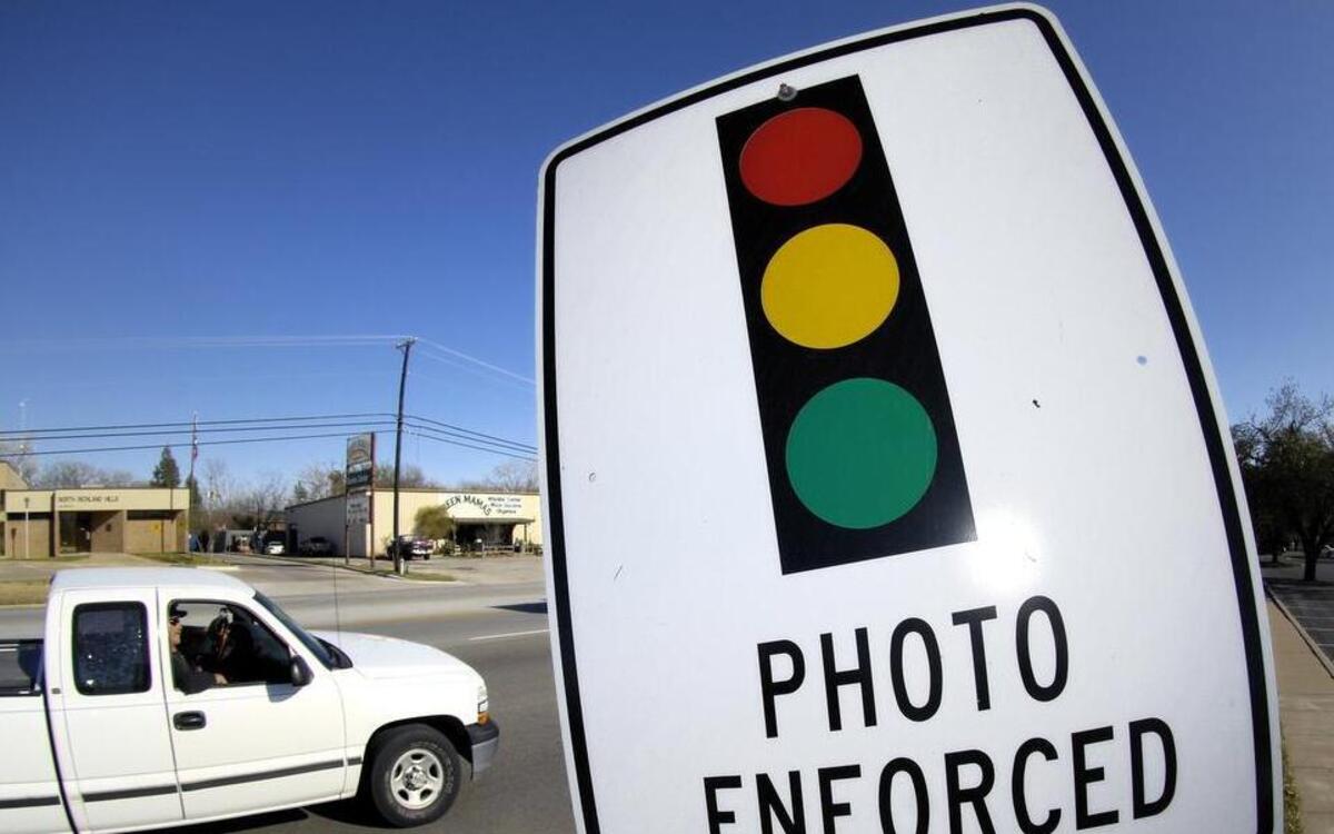 Signs warn drivers that red light cameras are ahead.