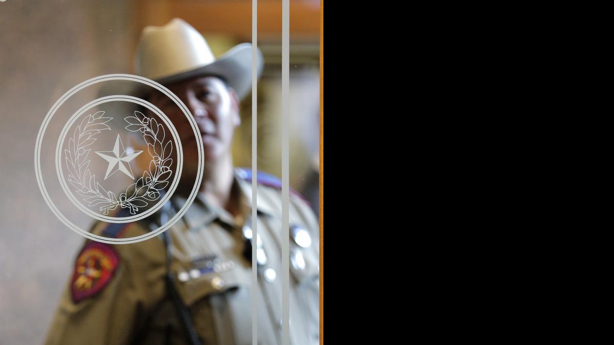
A Texas state trooper stands outside of a hearing where lawmakers discuss whether to legalize concealed handguns on college campuses and open carry everywhere else, Thursday, Feb. 12, 2015, in Austin. (AP Photo/Eric Gay)

