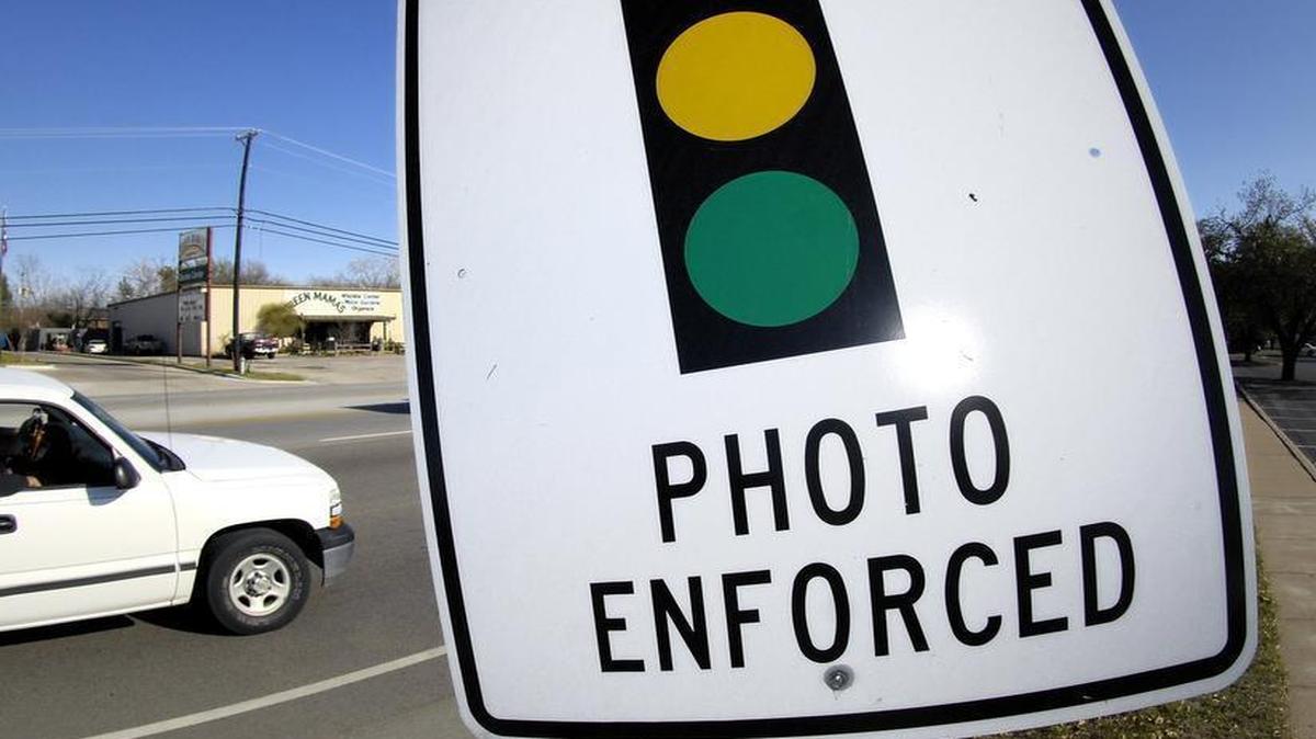 Signs across the state warn drivers that there are red light cameras ahead.