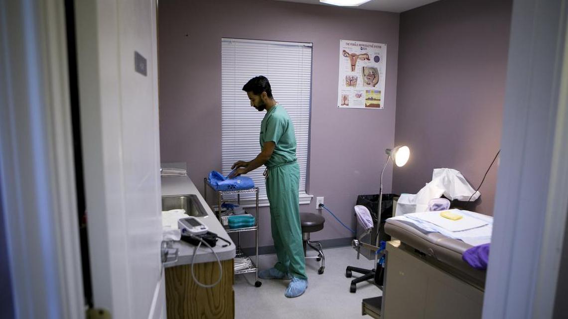 A doctor prepares an examination room for a patient in 2016 at Whole Woman’s Health clinic in Fort Worth. A new Texas law will limit medication abortions from being dispensed to anyone who is more than seven weeks pregnant, and will require the medications to be dispensed by a doctor in a clinic.