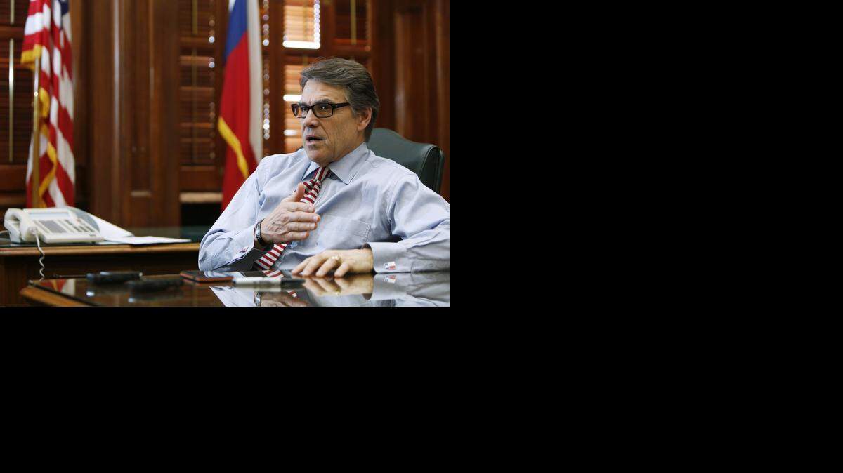 
Texas Gov. Rick Perry speaks during his last day as governor in his state capitol office. 

