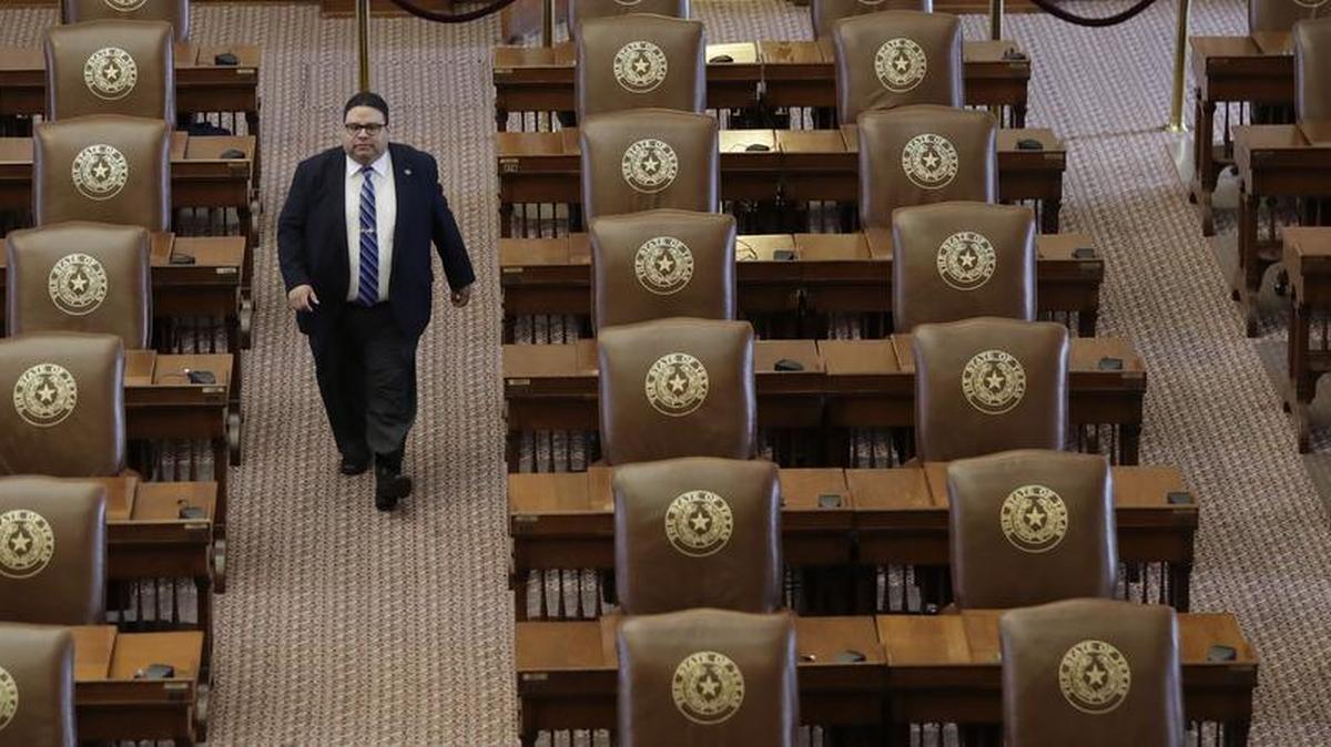 Texas House of Representatives Sergeant-at-Arms David Sauceda walks through an empty chamber, Wednesday in Austin. The Texas Legislature adjourned Tuesday and a Texas “bathroom bill” targeting transgender people died again along with many of Republican Gov. Greg Abbott’s summer demands.