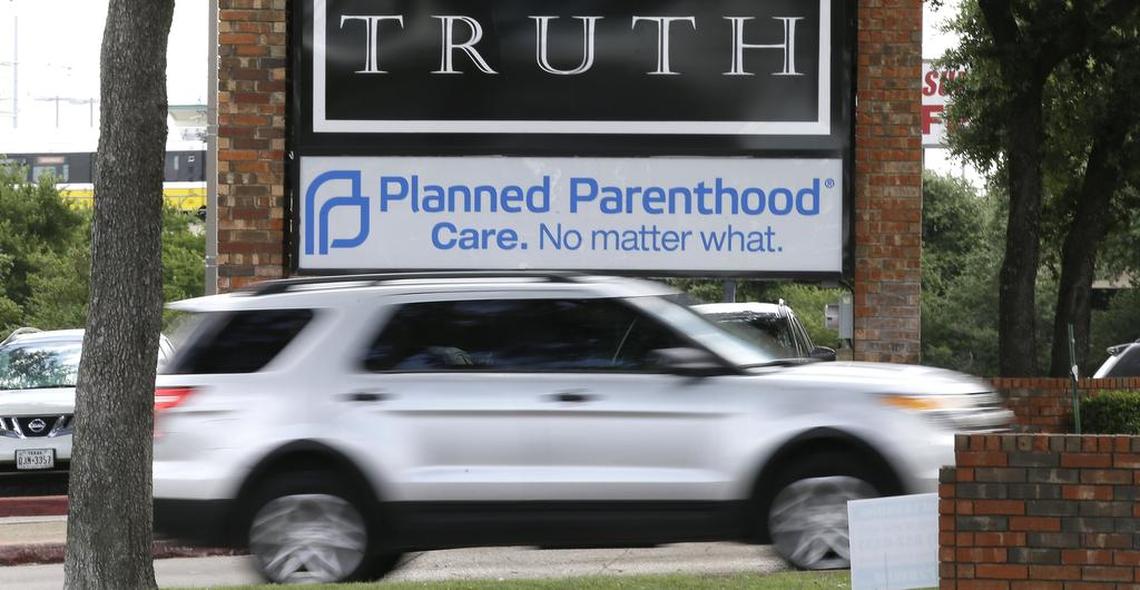 FILE: In a Monday, June 27, 2016, file photo, traffic passes a Planned Parenthood sign in Dallas. Abortions Abortions resumed Wednesday in Texas after Gov. Greg Abbott's executive order loosened restrictions amid the coronavirus pandemic. (AP Photo/LM Otero, File)