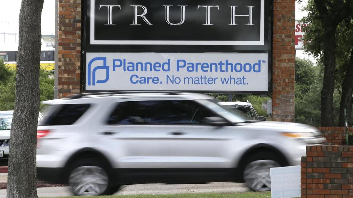 FILE: In a Monday, June 27, 2016 file photo, traffic passes a Planned Parenthood sign in Dallas. Abortions in Texas plummeted about 15 percent during the first year after approval of tough restrictions that the U.S. Supreme Court has since struck down â€” a decline that activists say shows how hard it had become to get an abortion in America's second-largest state. The health department released the statistics Thursday, June 30, 2016. (AP Photo/LM Otero, File)