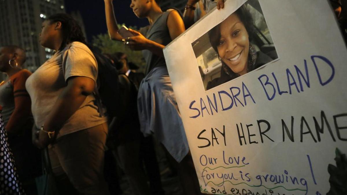 
FILE ART: A demonstraor holds a Sandra Bland sign during a vigil, Tuesday evening, July 28, 2015, near the DuSable Bridge on Michigan Ave. in Chicago. Bland died in a Texas county jail after the traffic stop for failing to use a turn signal escalated into a physical confrontation. Authorities have said Bland hanged herself, a finding her family disputes. The death has garnered national attention amid increased scrutiny of police treatment of blacks in the wake of several high-profile police-involved deaths. (AP Photo/Christian K. Lee)
