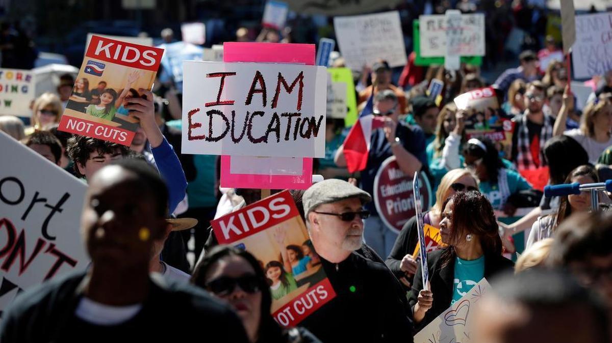FILE: In this Feb. 23, 2013 file photo, teachers, students, parents and school administrators march up Congress Avenue to the state Capitol, in Austin, Texas to a rally for Texas public schools. The Texas Supreme Court has declared the state's school finance system constitutional - a surprise defeat for 600-plus school districts that sued. (AP Photo/Eric Gay, File)