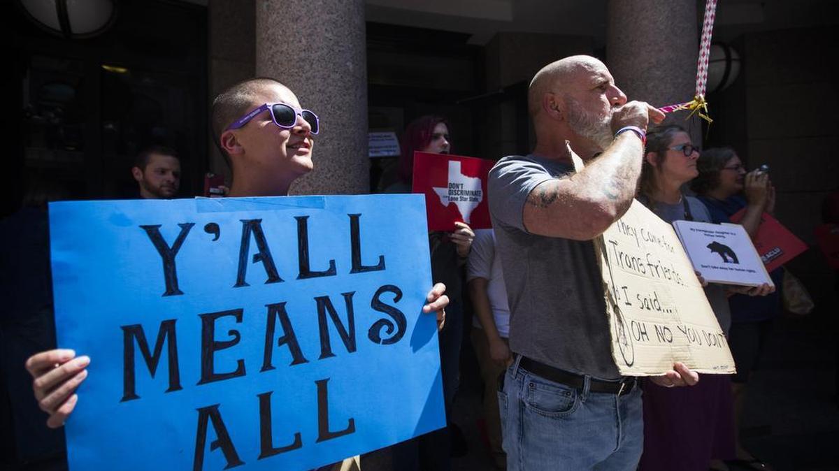 Siobhan Cooke of Nacogdoches, Texas, and Mark Jiminez of Dallas were among protesters rallying against the so-called bathroom bill during the special session.