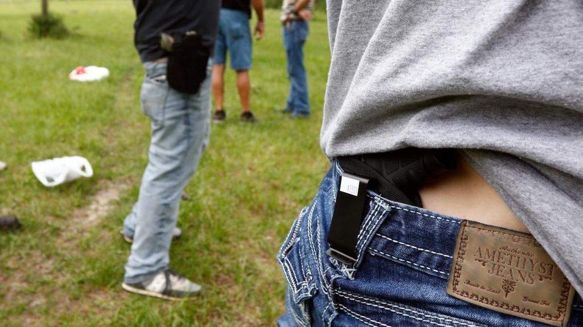 At a 2016 church-sponsored concealed carry class in Petal, Mississippi, a participant shows where she holsters her concealed firearm.