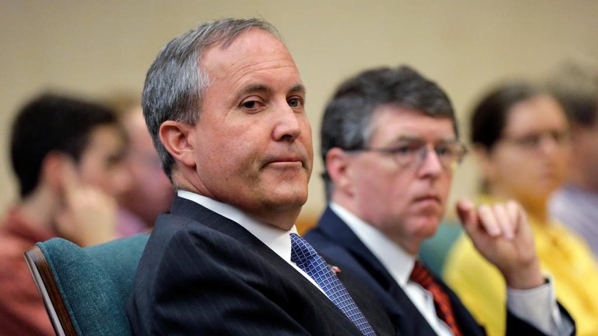 
Texas Attorney General Ken Paxton, left, with his chief of staff Bernie McNamee, right, waits to testify before a committee hearing last month in Austin. 

