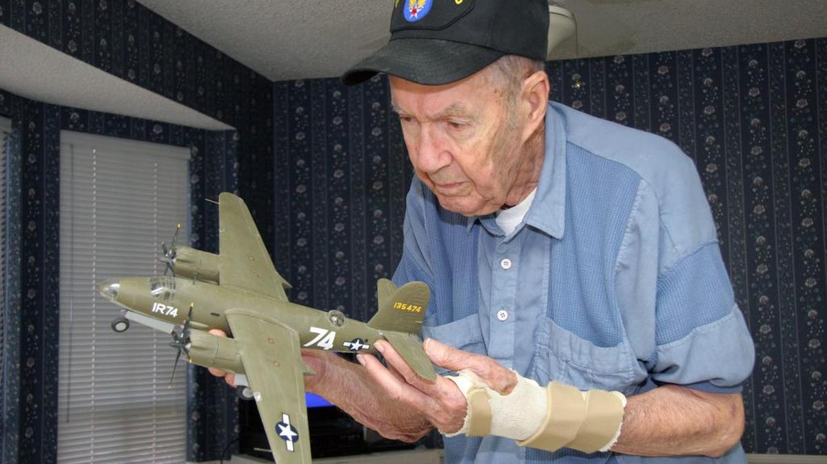 
Henry Jennings holds a model of the Martin B-26 World War II bomber that he served on as an engineer. Pilots had to work hard to fly the planes safely. 
