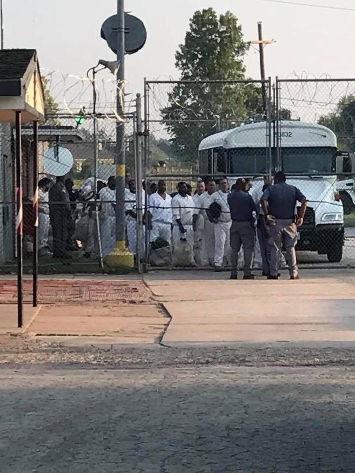 Prisoners wait in line Monday.