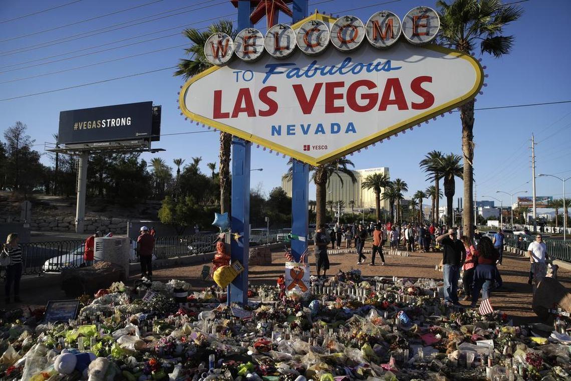 Flowers, candles and other items surround the famous Las Vegas sign at a makeshift memorial for victims of a mass shooting in Las Vegas. Stephen Paddock opened fire on an outdoor country music concert killing dozens and injuring hundreds.