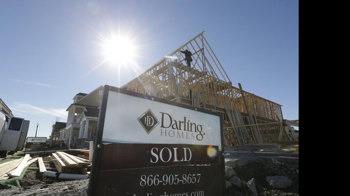 
In this Dec. 15, 2014 file photo, a sold sign sits in front of a house under construction in Coppell, Texas. The Commerce Department reports on sales of new homes in November on Tuesday, Dec. 23, 2014. (AP Photo/LM Otero)
